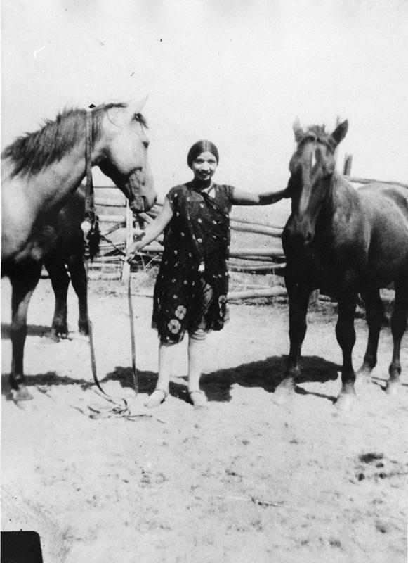 Lucy Friedlander standing between horses