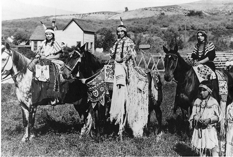 Three girls on horseback